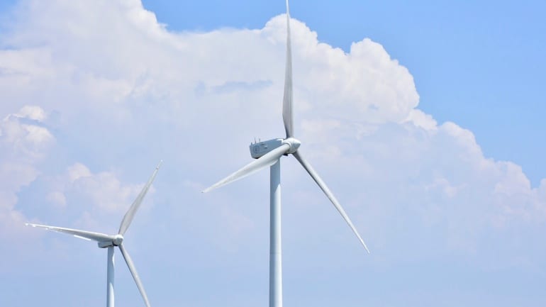 wind turbines clouds - Ndevr Environmental